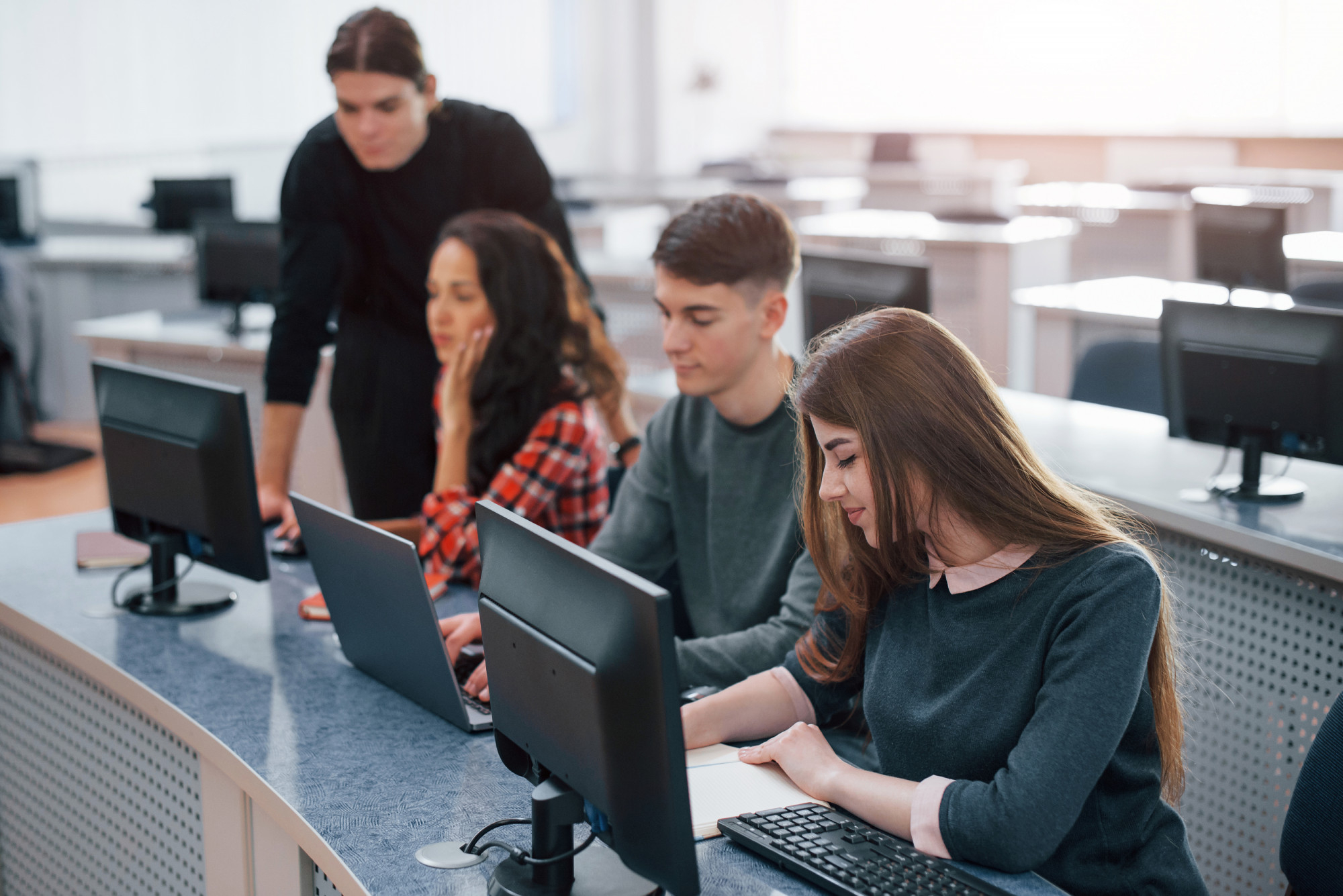 Teacher conducting real-time academic assessment in classroom